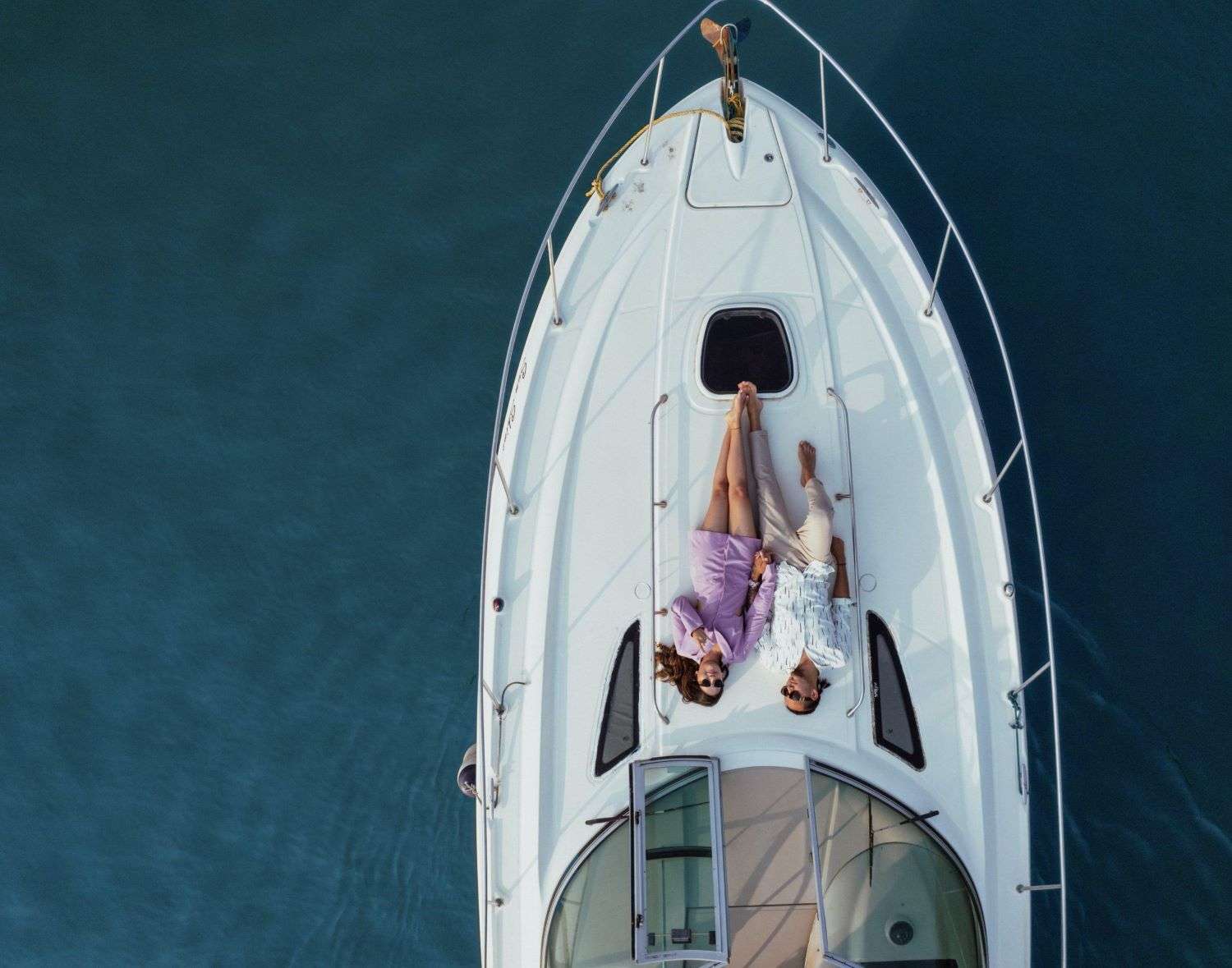 Couple enjoying a peaceful moment together while lounging on a yacht